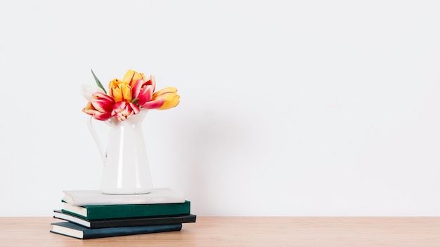 Pitcher with tulips on notepads