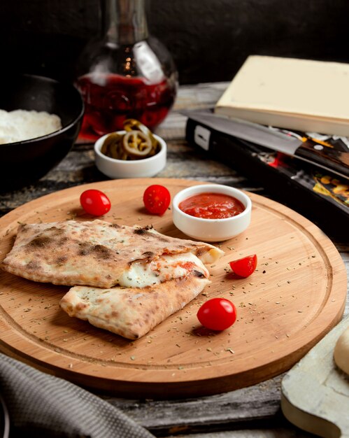 Pizza calzone on wooden board