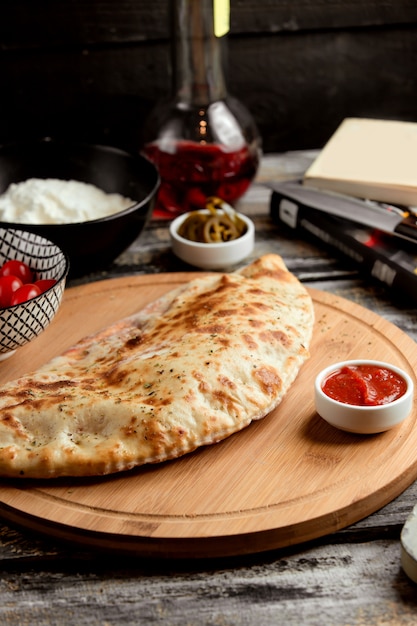 Pizza calzone on wooden board