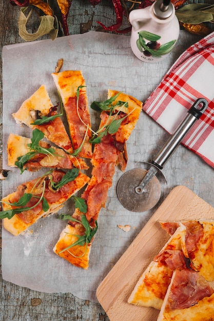 Pizza and cutter on table