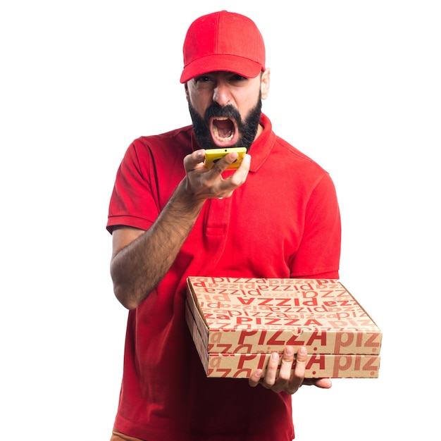 Free photo pizza delivery man holding a mobile