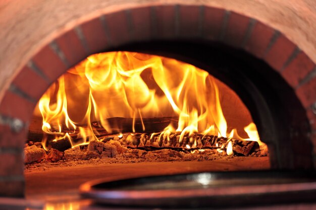 Pizza oven with fire in restaurant