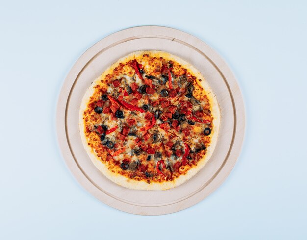 Pizza in a pizza board top view on a white background