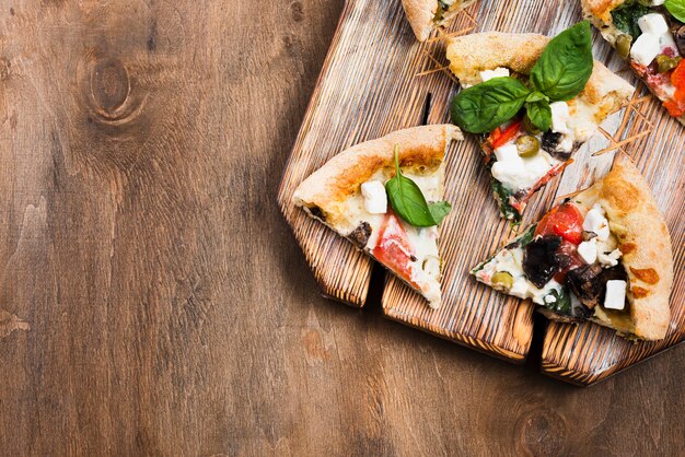 Pizza slices on cutting board top view