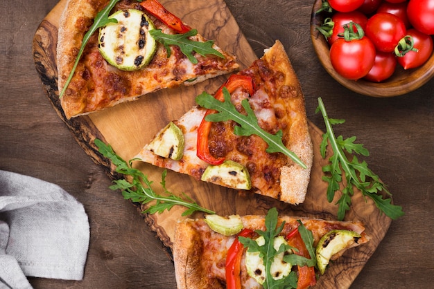Pizza slices on wooden board flat lay