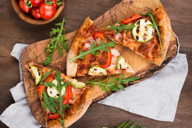 Pizza slices on wooden board top view