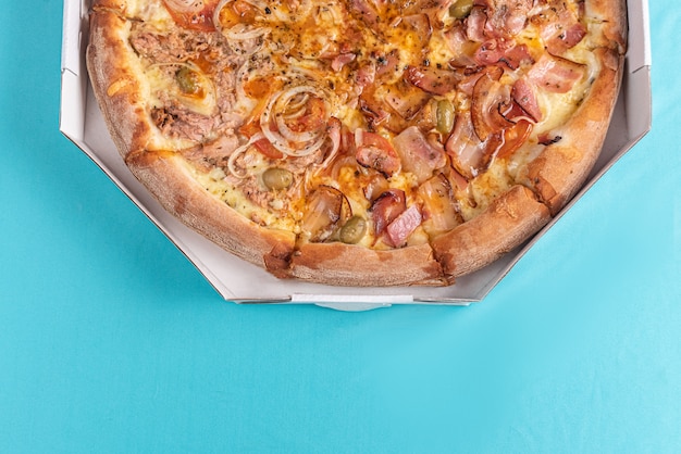 Pizza on the table in light blue color