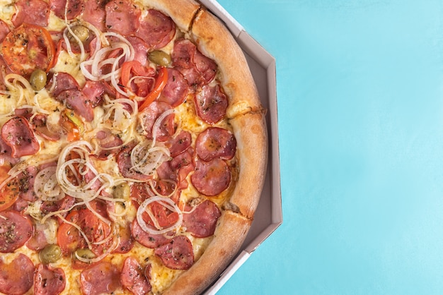 Pizza on the table in light blue color