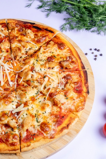 Pizza topped with extra cheese and herbs