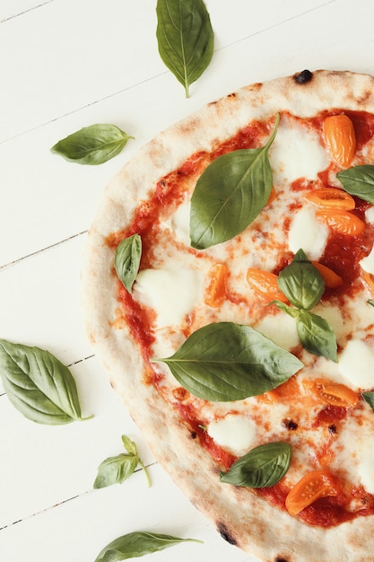 Pizza on white wooden table