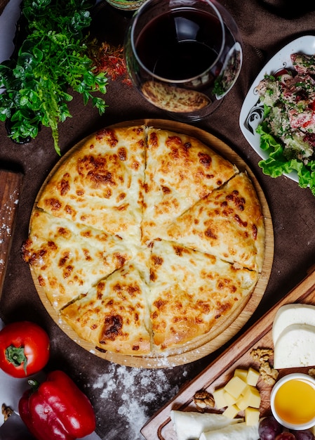 Pizza with cheese tomato and bell pepper on the table