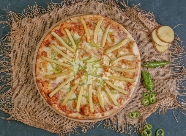 Pizza with fried potato sticks, tomato and green chili pepper