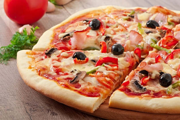 Pizza with ham, mushrooms and olives