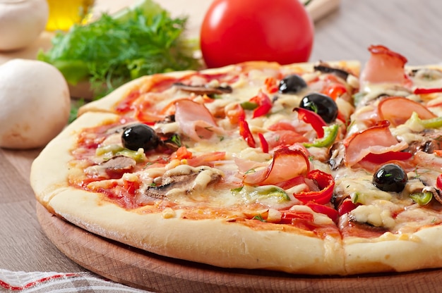 Pizza with ham, mushrooms and olives