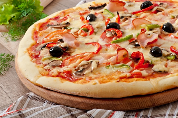 Pizza with ham, mushrooms and olives