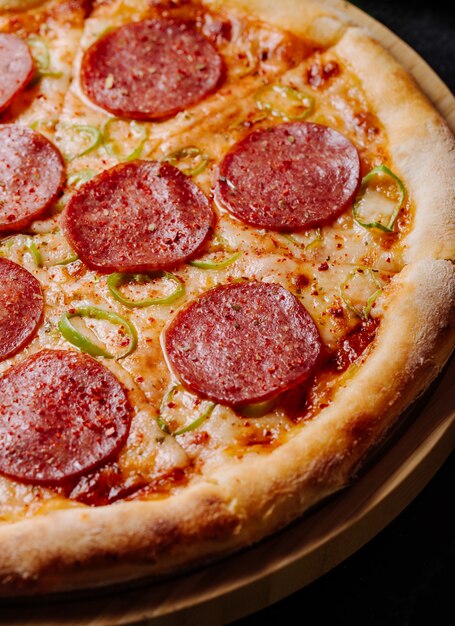 Пицца с кусочками пепперони и томатным соусом.