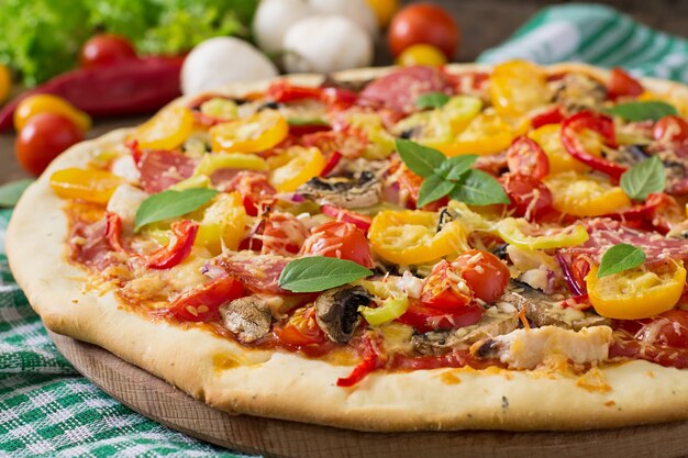 Pizza with salami, tomato, cheese and mushrooms