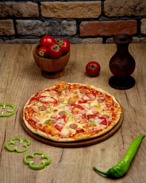 Pizza with sausages bell pepper tomato and cheese