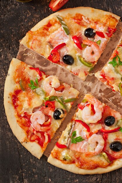 Pizza with shrimp, salmon and olives