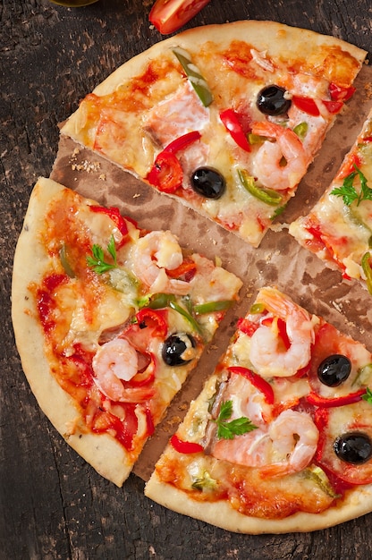 Pizza with shrimp, salmon and olives