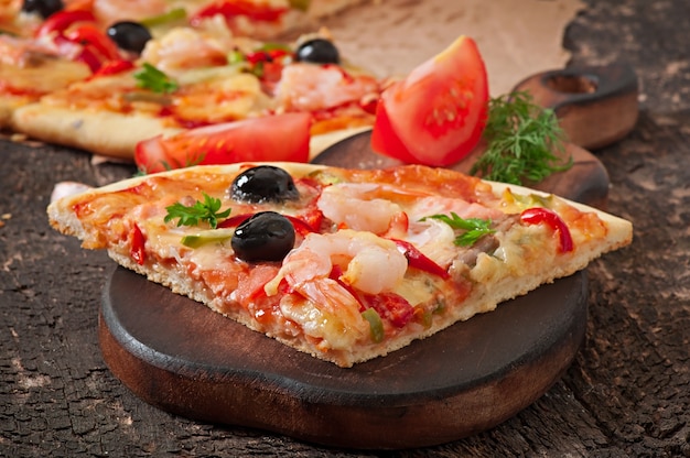 Pizza with shrimp, salmon and olives