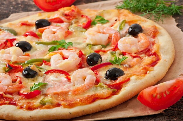 Pizza with shrimp, salmon and olives