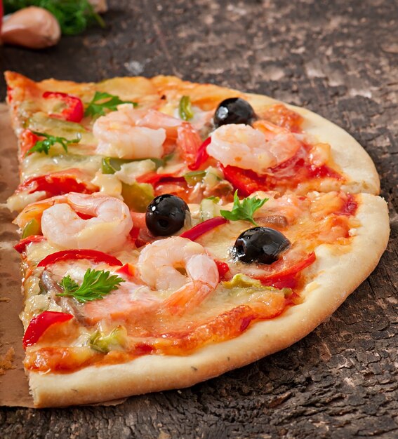 Pizza with shrimp, salmon and olives