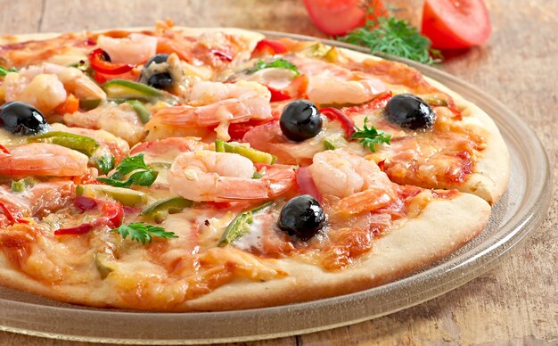 Pizza with shrimp, salmonnd olives