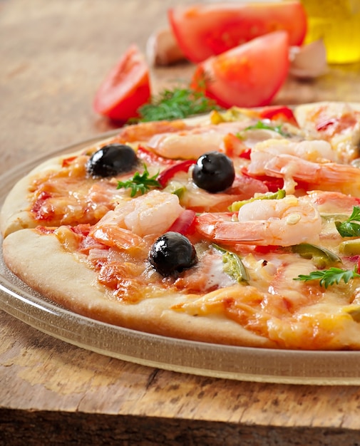 Pizza with shrimp, salmonnd olives