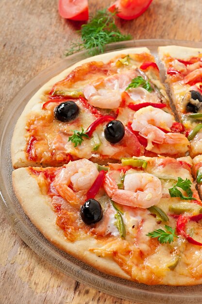 Pizza with shrimp, salmonnd olives