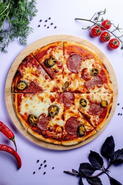 Pizza with side vegetables and herbs