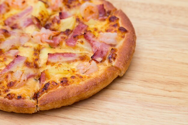 Pizza on a wooden table close up