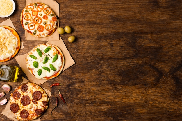 Free photo pizza on wooden table with copy space