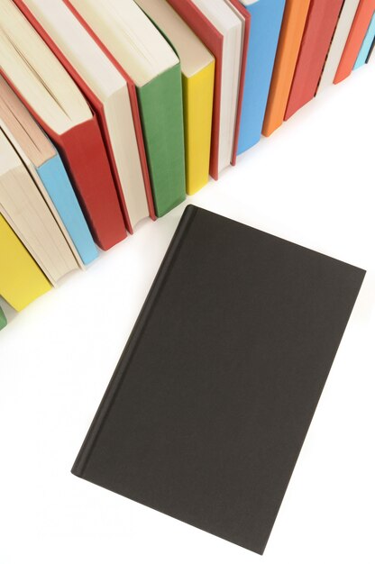 Plain black book with row of colorful books