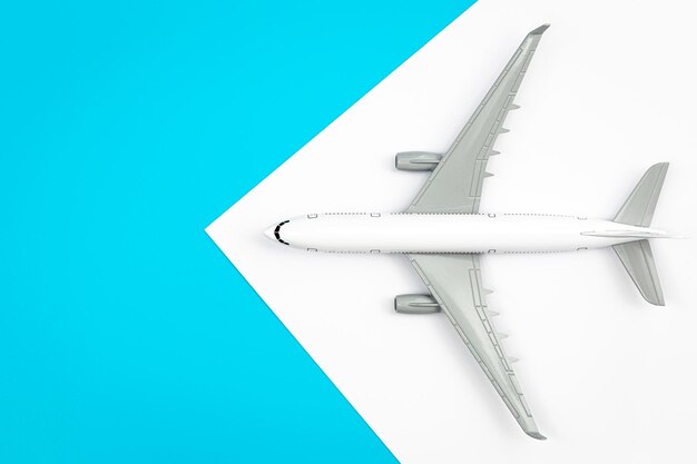 A plane airplane on a blue background flat lay copy space
