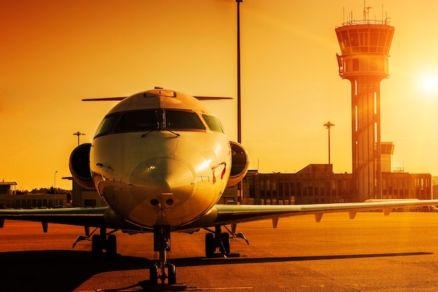 Plane at airport in sunset