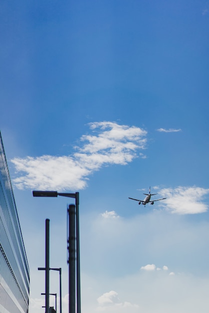 the plane is flying in the blue sky