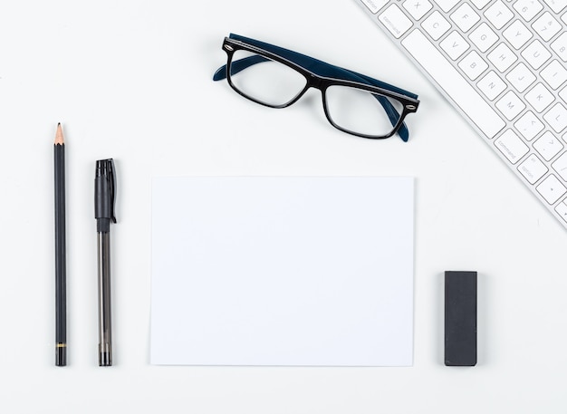 Free photo planning concept with pen, pencil, eraser, eyeglasses, paper, keyboard on white background space for text, top view. horizontal image