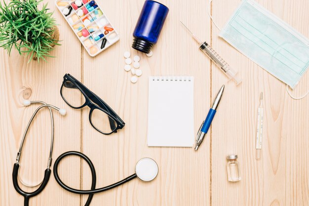 Plant and medical supplies around notebook