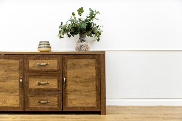 Plant in vase on wooden furniture