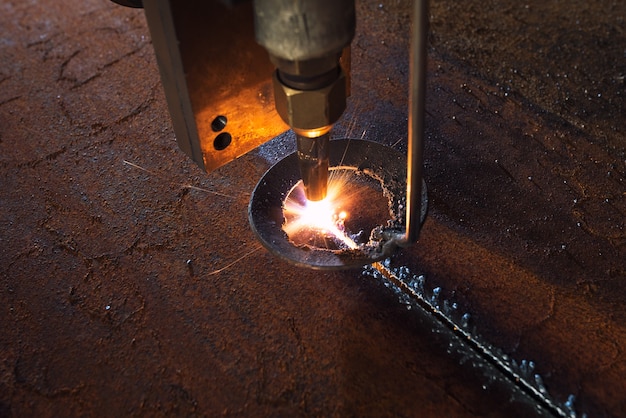 Plasma laser cnc industrial machine cutting iron and steel in metalwork workshop