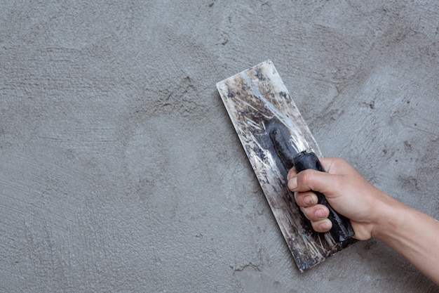 Plasterer renovating indoor walls.