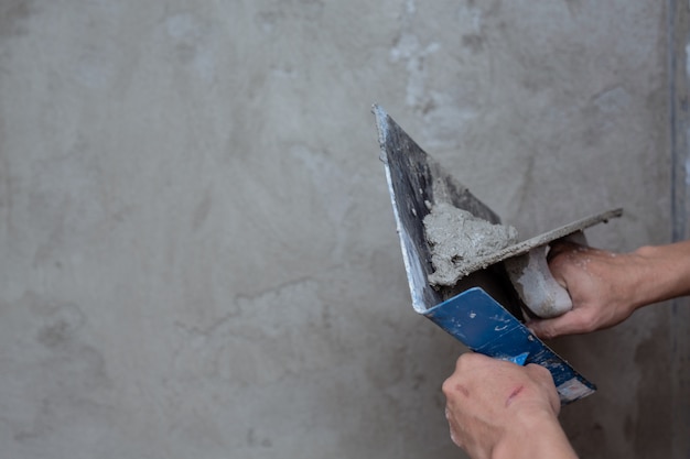 Free photo plasterer renovating indoor walls.