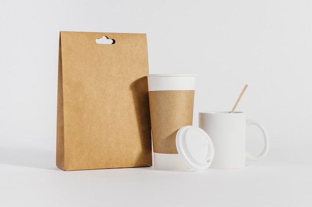 Plastic cup and mug next to bag