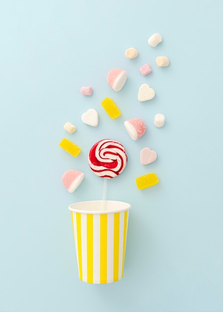 Free photo plastic cup with lollipop