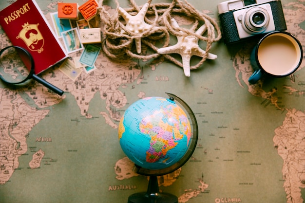 Plastic globe on table with touristic set