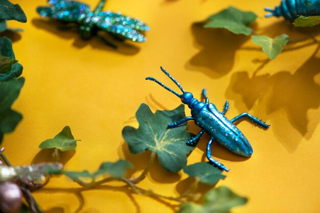 Plastic insect among green leaves