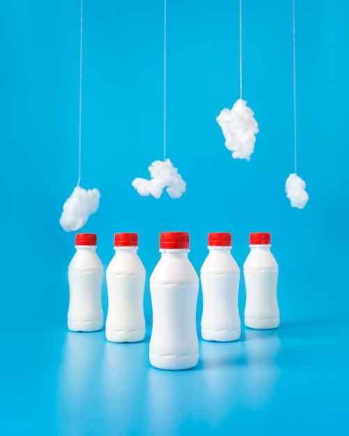 Free photo plastic milk bottles and hanging clouds