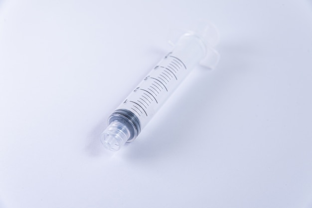 Plastic syringe on the white background