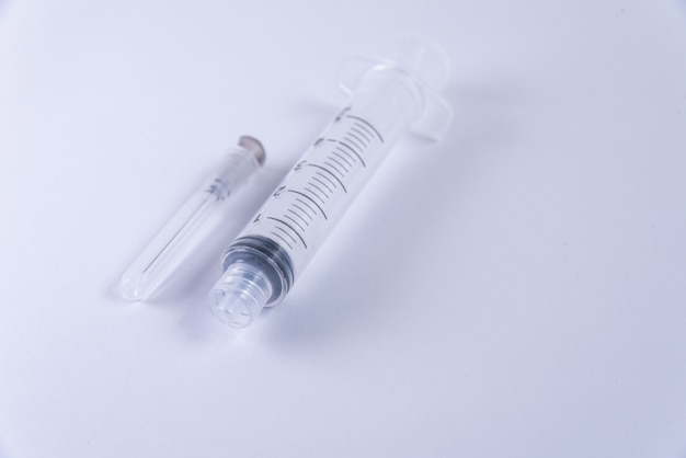 Plastic syringe on the white background